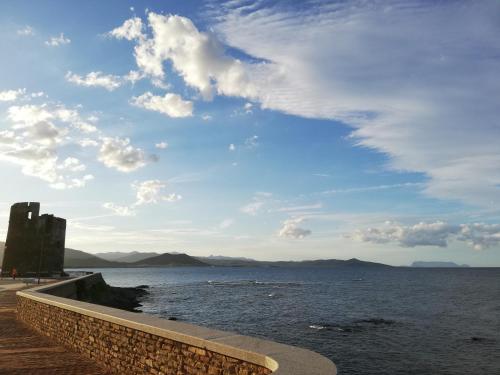 a view of a body of water with a building at Casa a pochi passi dal mare in La Caletta