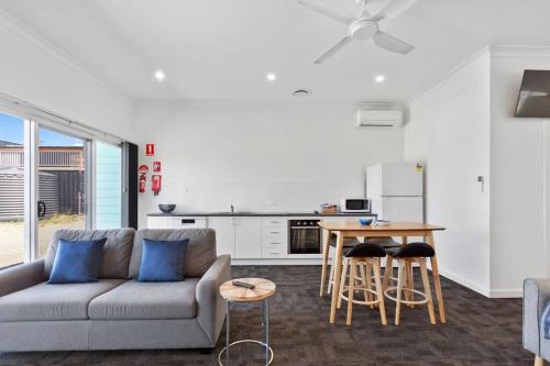 a living room with a couch and a table at Port Lincoln Shark Apartment 4 in Port Lincoln