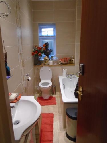a bathroom with a toilet and a sink at Edgware B&B in Barnet