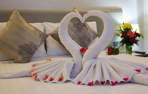 a swan made out of towels on a bed at ON Hotel Phuket - SHA in Karon Beach