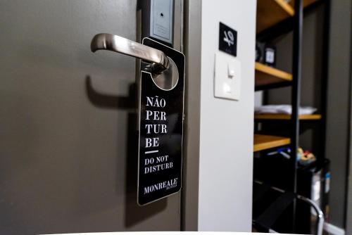 a sign on a door that reads no pee try be not way disturbed at Monreale Lifestyle Higienópolis São Paulo in Sao Paulo