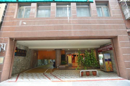 a person standing in front of a building at Hua Guo Hotel in Keelung