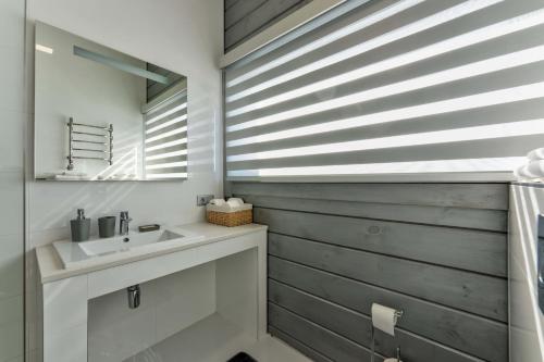 a bathroom with a sink and a mirror at Vila Cigota Zlatibor in Zlatibor