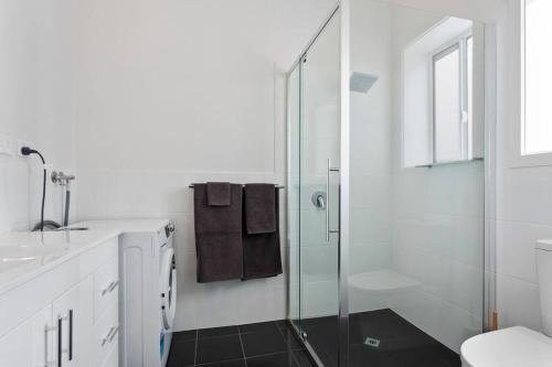 a bathroom with a glass shower and a sink at Port Lincoln Shark Apartment 5 in Port Lincoln