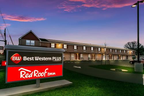 a red best western plus sign in front of a building at Red Roof Inn Hershey in Hershey