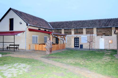 a barn with a large yard in front of it at VILA VASILIJE in Novi Kneževac