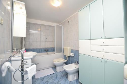 a bathroom with a toilet and a sink at Apartment Visnja in Rijeka