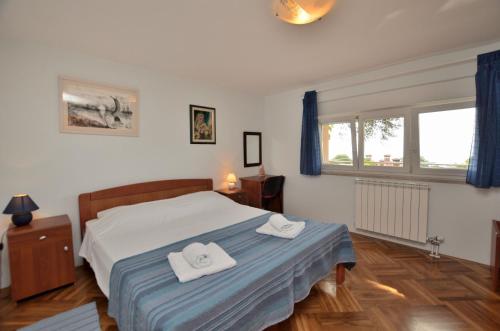 a bedroom with a bed with two towels on it at Apartment Visnja in Rijeka