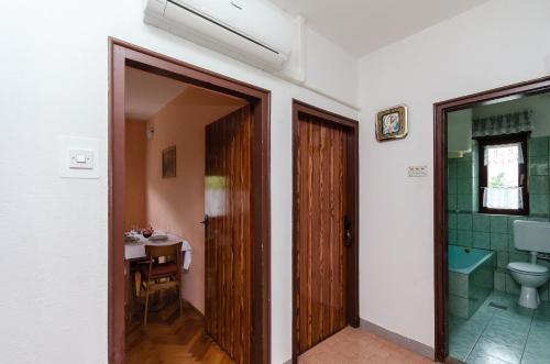 a bathroom with a toilet and a sink at Apartment Ivanka in Banjol
