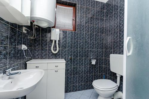 a bathroom with a toilet and a sink at Apartments Zorka in Kampor