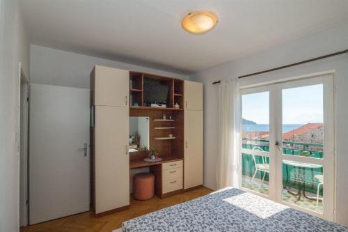 a bedroom with a bed and a large window at Apartments Tolj in Igrane