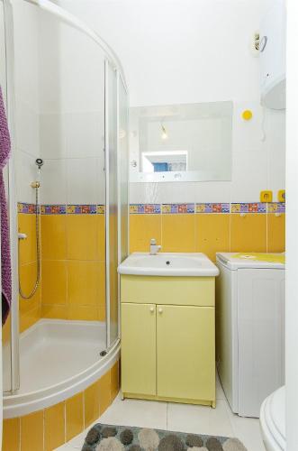 a bathroom with a sink and a shower and a toilet at House Mladen in Grohote