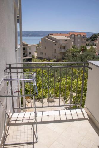 a balcony with a chair on a balcony at Apartments and Rooms Nikola in Omiš
