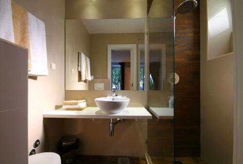 a bathroom with a sink and a glass shower at Apartments Ivanovic in Budva