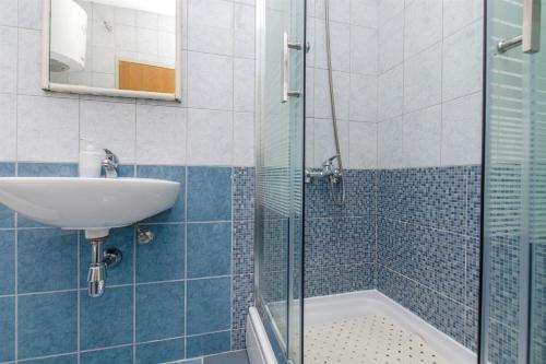 a bathroom with a sink and a shower at Apartment Studenka in Makarska