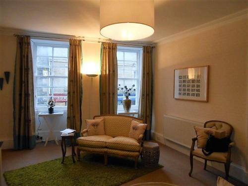 a living room with a couch and a chair and a window at Montrose Apartment in Selkirk