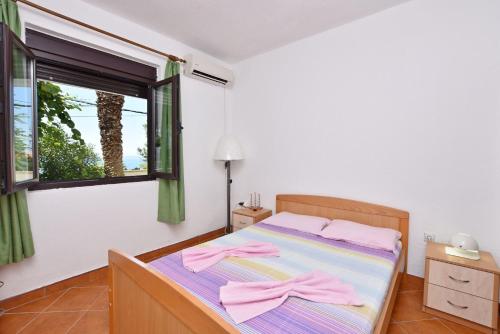 a bedroom with a bed with pink towels on it at Apartments Aleksandar in Ulcinj