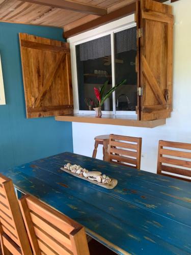 a blue table with chairs and a window at Deep Blu Apartment in Carmen
