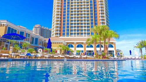 a swimming pool in front of a hotel with buildings at Portofino Tower 3 Unit 1609 in Pensacola Beach