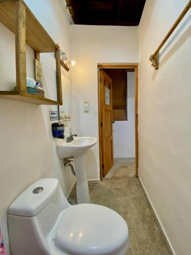 a bathroom with a toilet and a sink at Cabañas Frida in Chelem