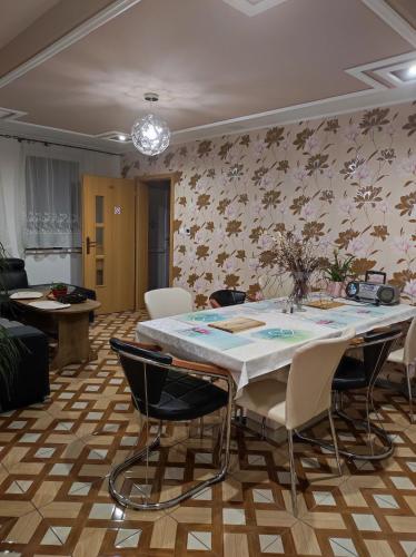 a dining room with a table and chairs at Ubytovňa Ivona in Hroboňovo