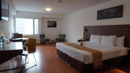 a hotel room with a bed and a table and chairs at Casa Andina Select Miraflores in Lima