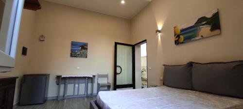 a bedroom with a bed and a large window at Camera Nta Cantunera in San Biagio