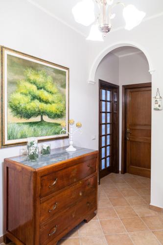 a dresser in a room with a painting on the wall at Dolce Sosta in Lucca
