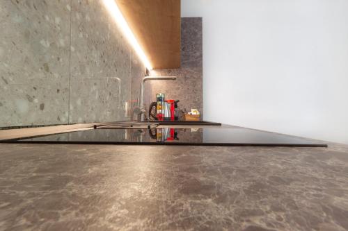 a kitchen with a sink and a counter top at Araliki Suites in Polykhrono