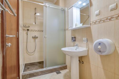 a bathroom with a sink and a shower at Garni Hotel Milica in Herceg-Novi