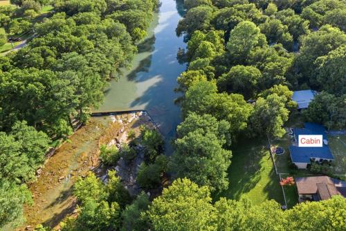 an aerial view of a river with a house and trees at Stone River Cabin in Canyon Lake