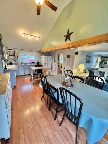 a kitchen and living room with a table and chairs at MARY'S LAKEVIEW - LIMIT 10 home in North Sebago