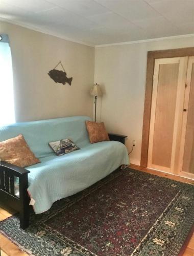 a bedroom with a blue bed in a room at MARY'S LAKEVIEW - LIMIT 10 home in North Sebago