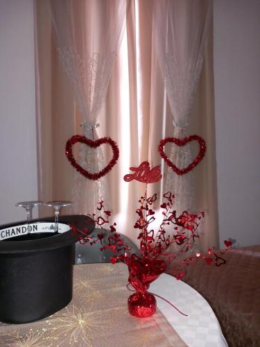 a table with two hearts decorations on top of it at Mary Gery's Rooms in Castellammare del Golfo