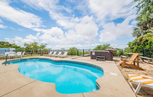 a swimming pool with a picnic table and chairs at D4414 Exhibit Sea. Soundfront, Stunning Sunsets, Pier, Private Pool & Hot Tub! in Sanderling