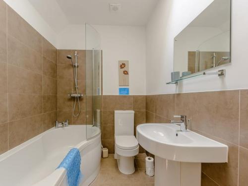 a bathroom with a sink and a toilet and a bath tub at Stone Cottage in Shrewsbury