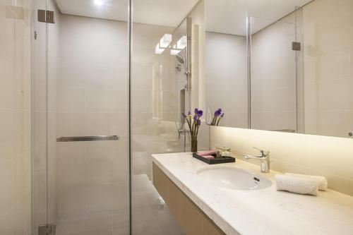 a bathroom with a sink and a shower at Citadines Intime City Hangzhou in Hangzhou