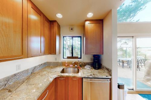 a kitchen with wooden cabinets and a sink at Happy Clam Hideaway in Lincoln City