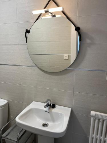 a bathroom with a sink and a mirror at Paz Jardín-Madrigueras in Madrigueras