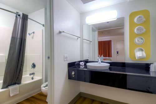 a bathroom with a sink and a mirror at Motel 6-Palm Springs, CA - Downtown in Palm Springs