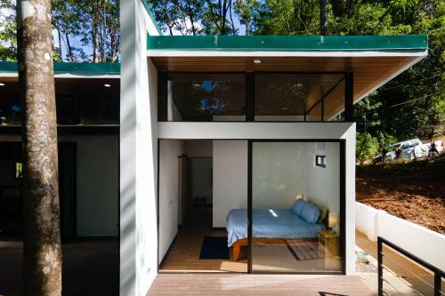 a small house with a bed inside of it at Casa Henaway - Portasol Vacation in Savegre
