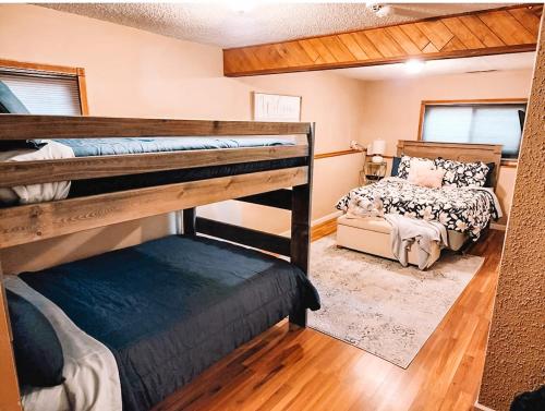 a bedroom with two bunk beds and a couch at Pet Friendly 2 King Beds AF Academy Sleeps 12 in Colorado Springs