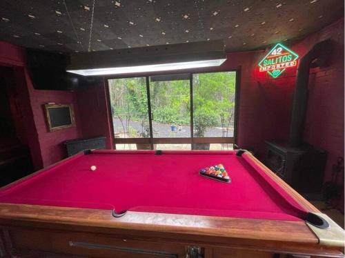 a large red pool table in a room at Sweeping views of Hanging Rock and Cobaw Ranges in Mount Macedon