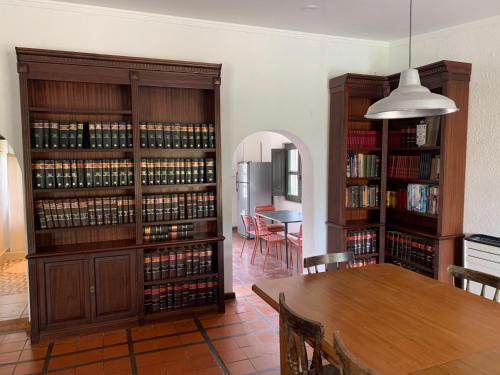 a dining room with a table and some book shelves at Las Marias in Tandil