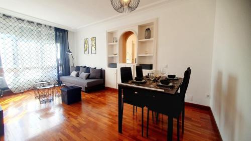 - un salon avec une table et un canapé dans l'établissement La Luz de Acevedo, à Oviedo