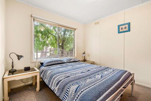 a bedroom with a bed and a window at Ventnor Getaway in Ventnor