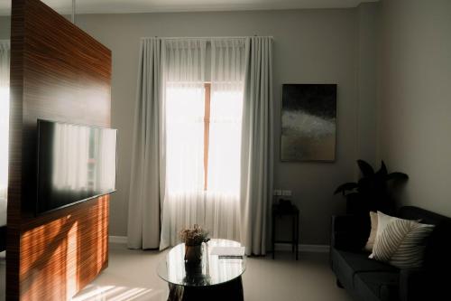 a living room with a tv and a window at Patio by Balai Norte in San Juan