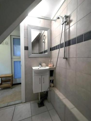 a bathroom with a sink and a mirror at Bed & Healing in Undløse