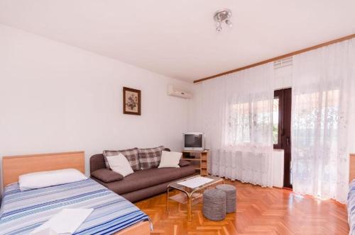 a living room with a bed and a couch at Apartments Nenad in Dramalj