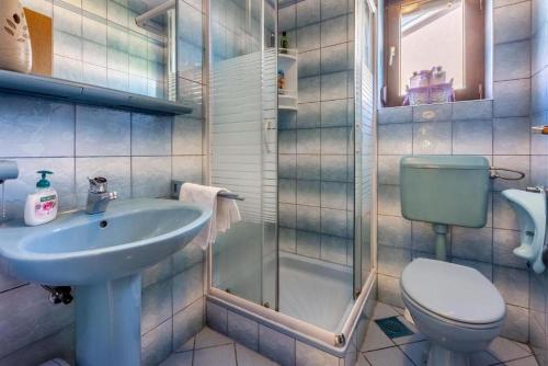 a bathroom with a sink and a toilet and a shower at Apartment Klaudia in Dramalj